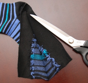 Cut straight down the sole of the socks